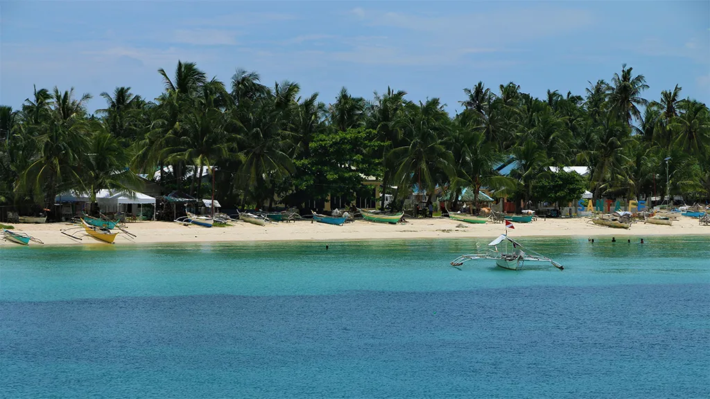A beach on Bantayan Island with a bangka just offshore