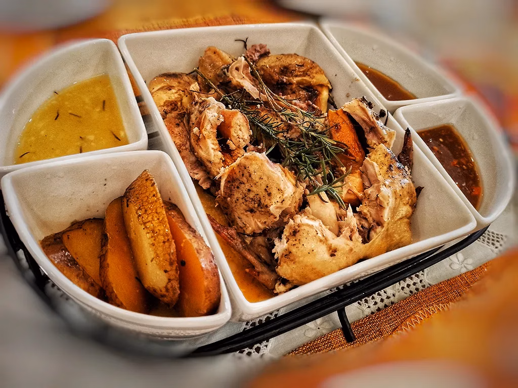 This guide to Bacolod considers chicken inasal a must-try dish. This is a picture of a fabulous dinner comprised of chicken inasal with potatoes and sauces.