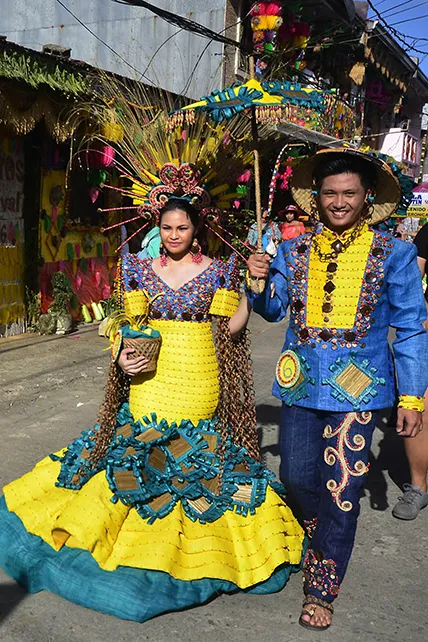 This is a picture of a man and a woman in full festival costumes. The Pahiyas Festival celebrates a plentiful harvest.