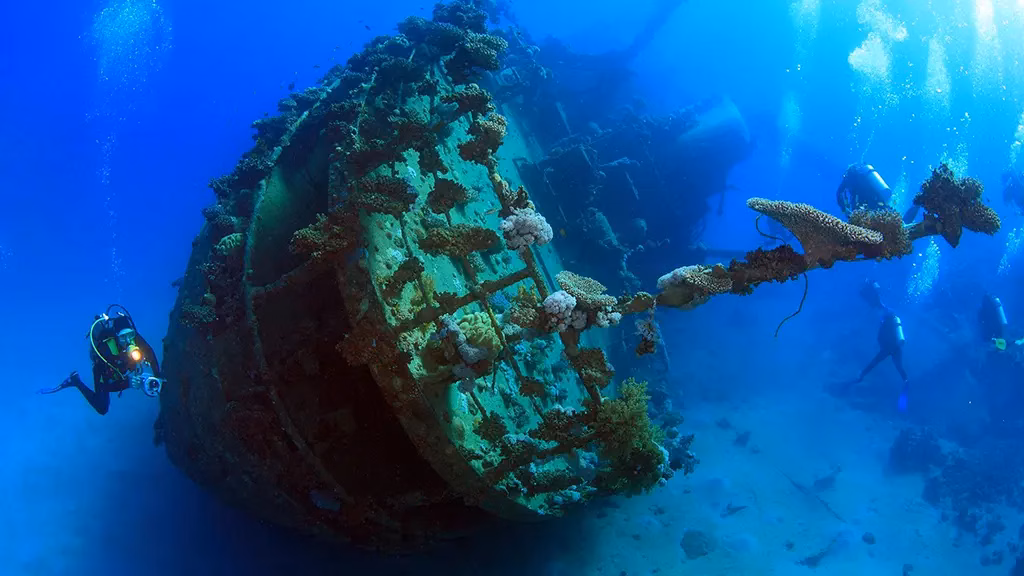 This is an underwater picture of a diver approaching a shipwreck in Palawan.