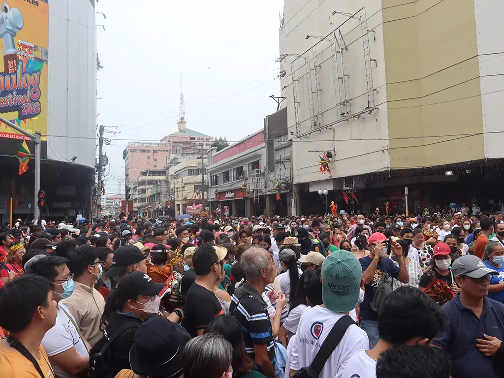 Tens of thousands of devotees pack Colon Street in Cebu City during the 2023 Sinulog Festival Solemn Walk Procession, carrying Santo Niño statues through the crowd as part of the annual religious pilgrimage honoring Señor Santo Niño.