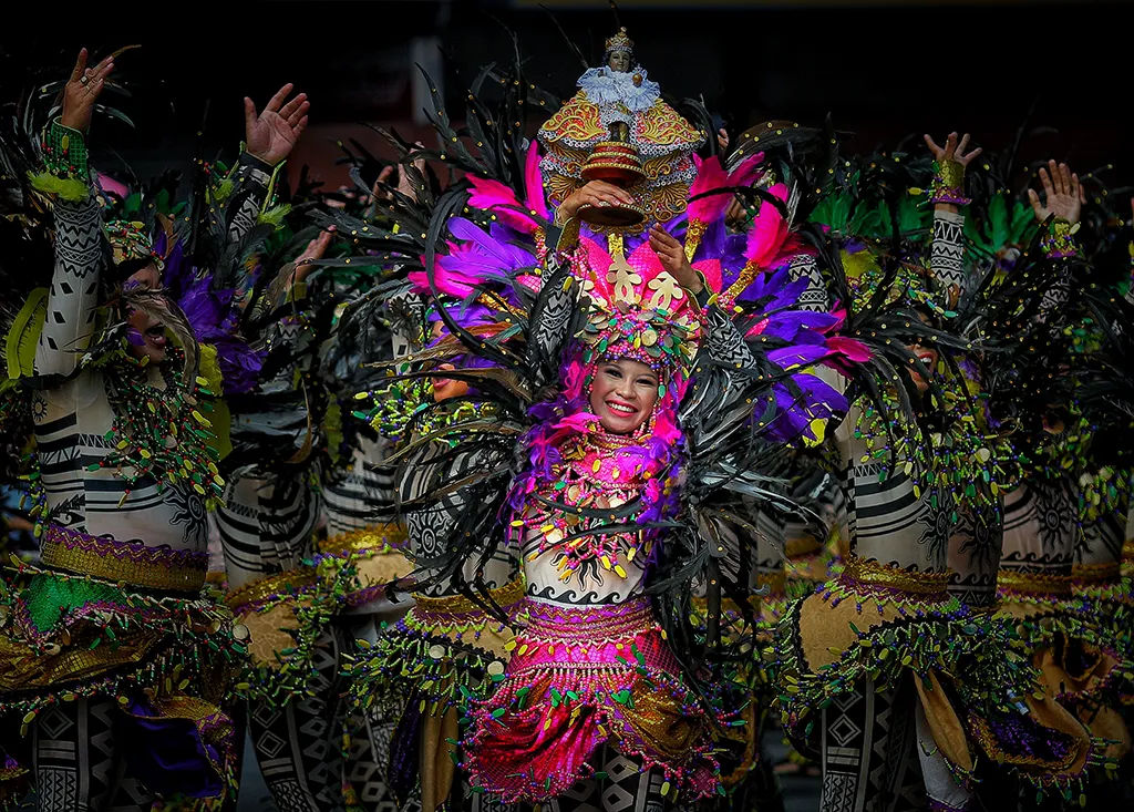 A brightly colored costume adorning a young woman dancing during the Sinulog Festival in Cebu City.