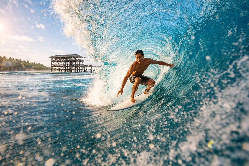 Cloud 9 surf break, Siargao, Philippines, surfer riding a wave, tropical surfing destination.